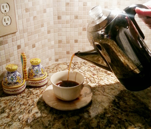 Pouring from a coffee percolator.