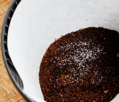 A pinch of salt in your coffee before brewing.