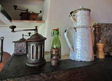 Antique coffee mills and a coffee pot.