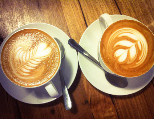 Two lattes on table.