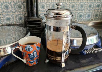 French pressed coffee keeping warm on an old-fashioned stove.