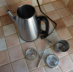 Parts of a stove top percolator, including a spring on the stem