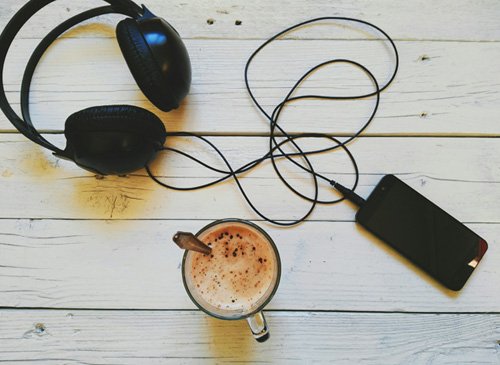 Coffee, headphones and a music player.