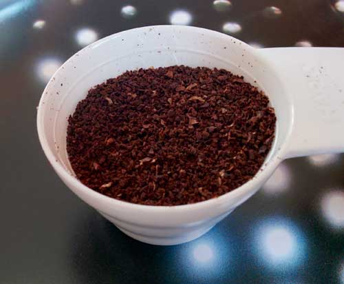 Coffee scoop filled with ground coffee