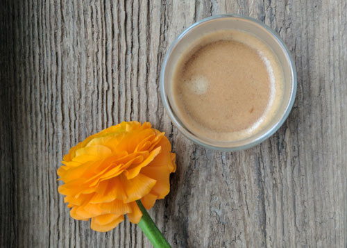 espresso and an orange flower