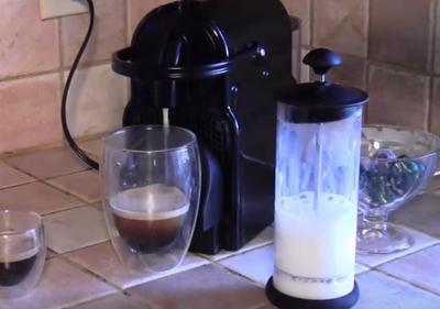 An espresso machine and hand milk frother.