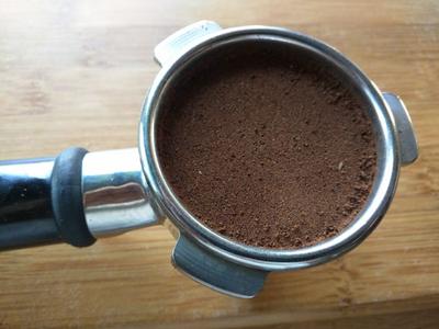 Portafilter packed with coffee grinds of the correct size.