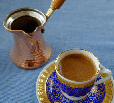 An Ibrik and a demitasse with Turkish coffee.