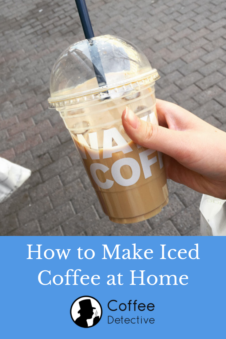 Holding a cup of iced coffee drink
