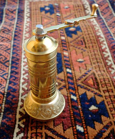 A brass Turkish coffee grinder