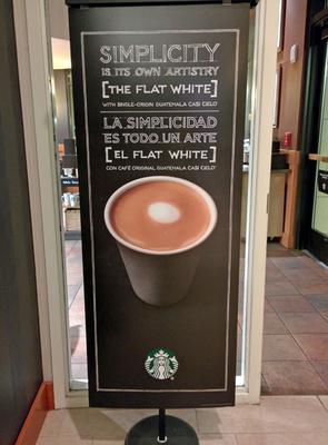 Starbucks signage for Flat White coffee.